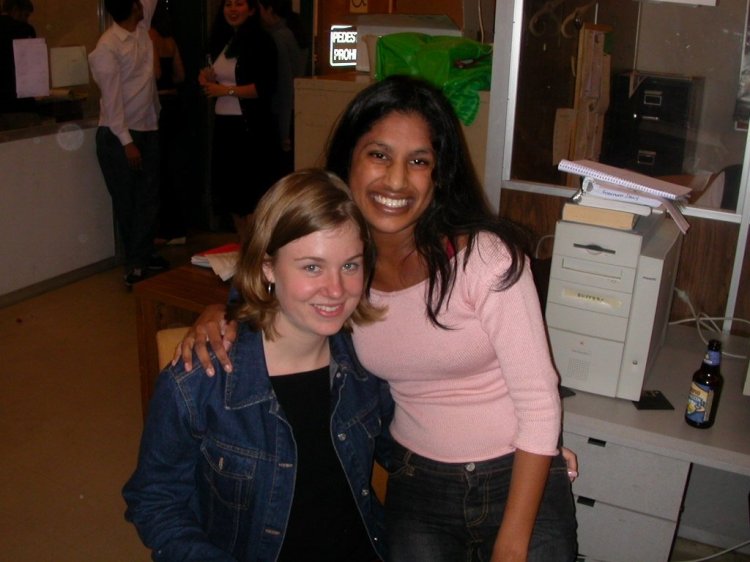 Two women smile next to each other